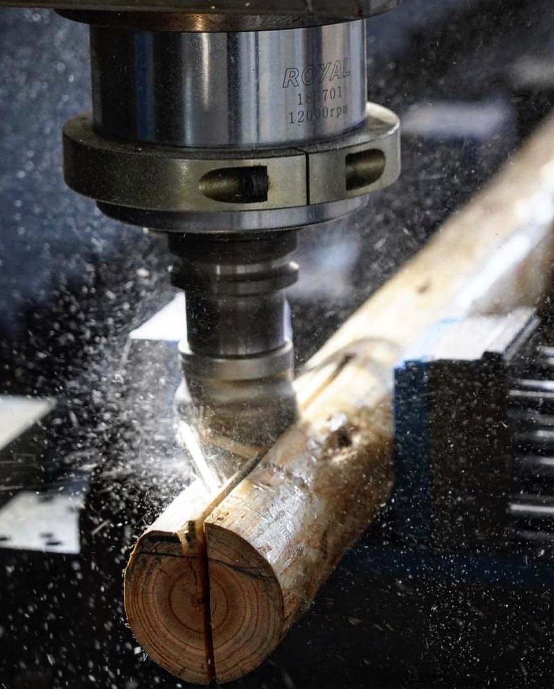 "Close-up of a CNC machine cutting a wooden log, showcasing precision craftsmanship for geodesic dome construction, ideal for luxury glamping solutions and sustainable living. Keywords: geodesic dome kit, dome home, glamping pods for sale."