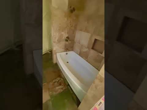 Alt text: "Interior view of a bathroom with a bathtub and tiled walls, showcasing potential design elements for a luxury glamping pod or geodesic dome home."