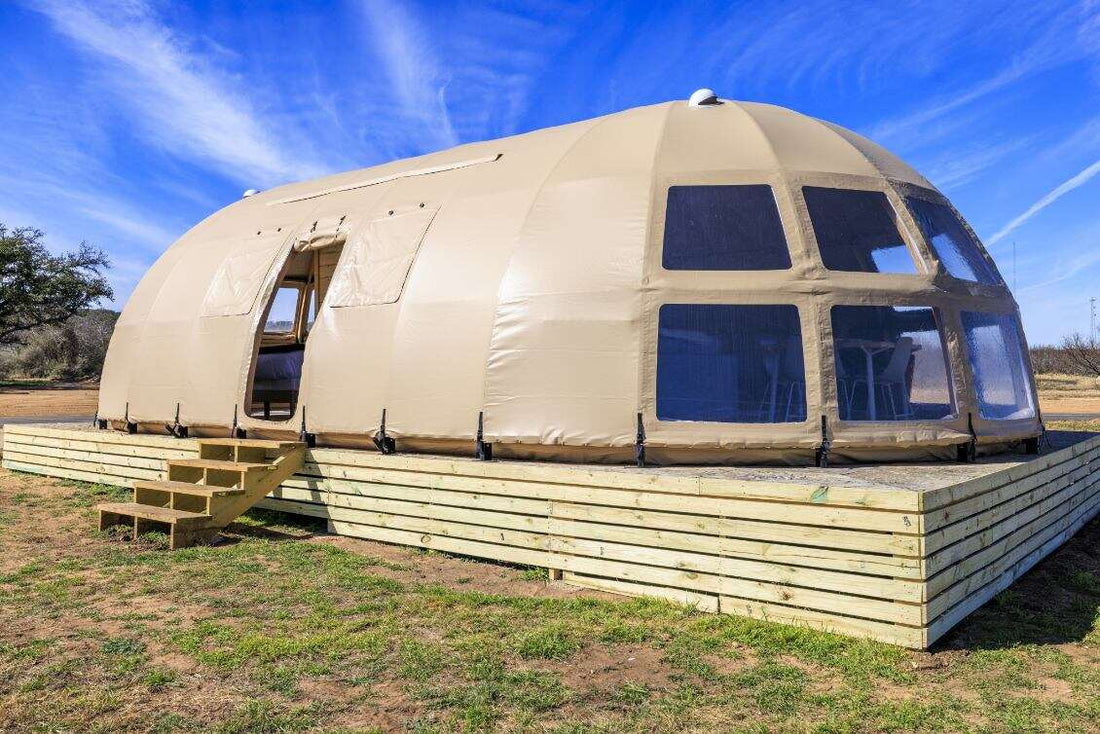Alt text: "Spacious geodesic dome with porthole windows on a wooden platform, ideal for glamping or a luxury Airbnb experience. This large dome tent offers a stylish and sustainable living solution, perfect for a backyard dome or geodesic home setup."