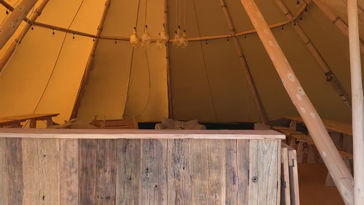 Alt text: &quot;Interior of a spacious glamping teepee with wooden beams and rustic decor, showcasing a cozy and stylish environment for luxury camping experiences. Ideal for those interested in geodesic dome house kits, glamping pods for sale, and outdoor dome living.&quot;